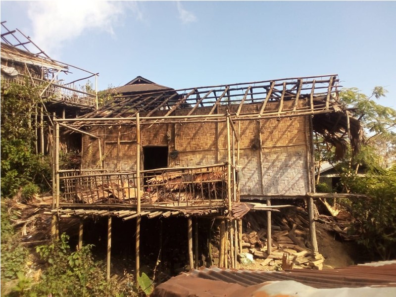 Villagers look on at the remnants of a house that was razed in a fire in Wakching village on November 8. (Morung Photo)